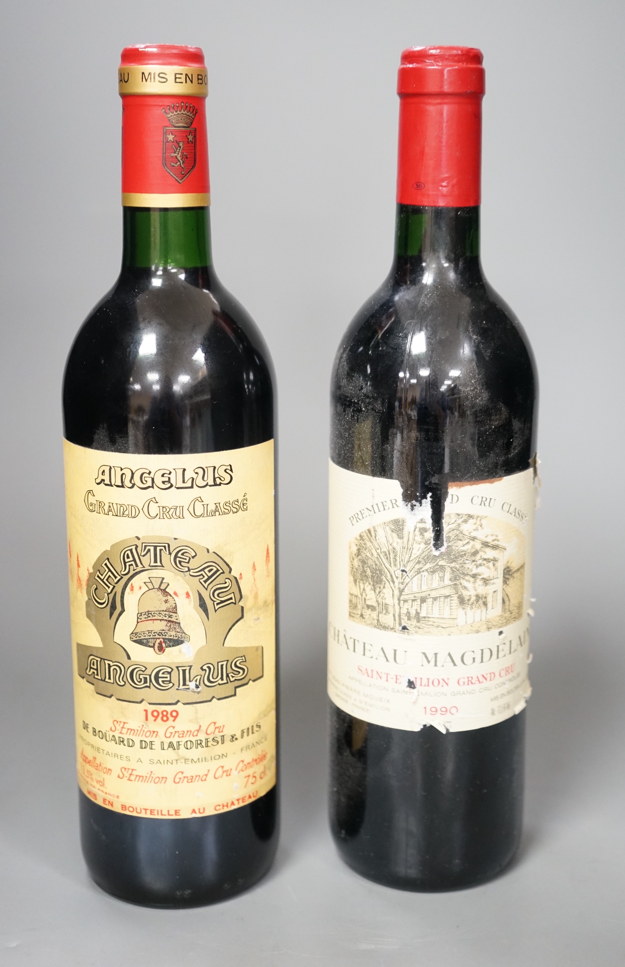 Two bottles of wine: Chateau Magdelaine St. Emilion Grand Cru 1990 and Chateau Angelus St Emilion Grand Cru 1998